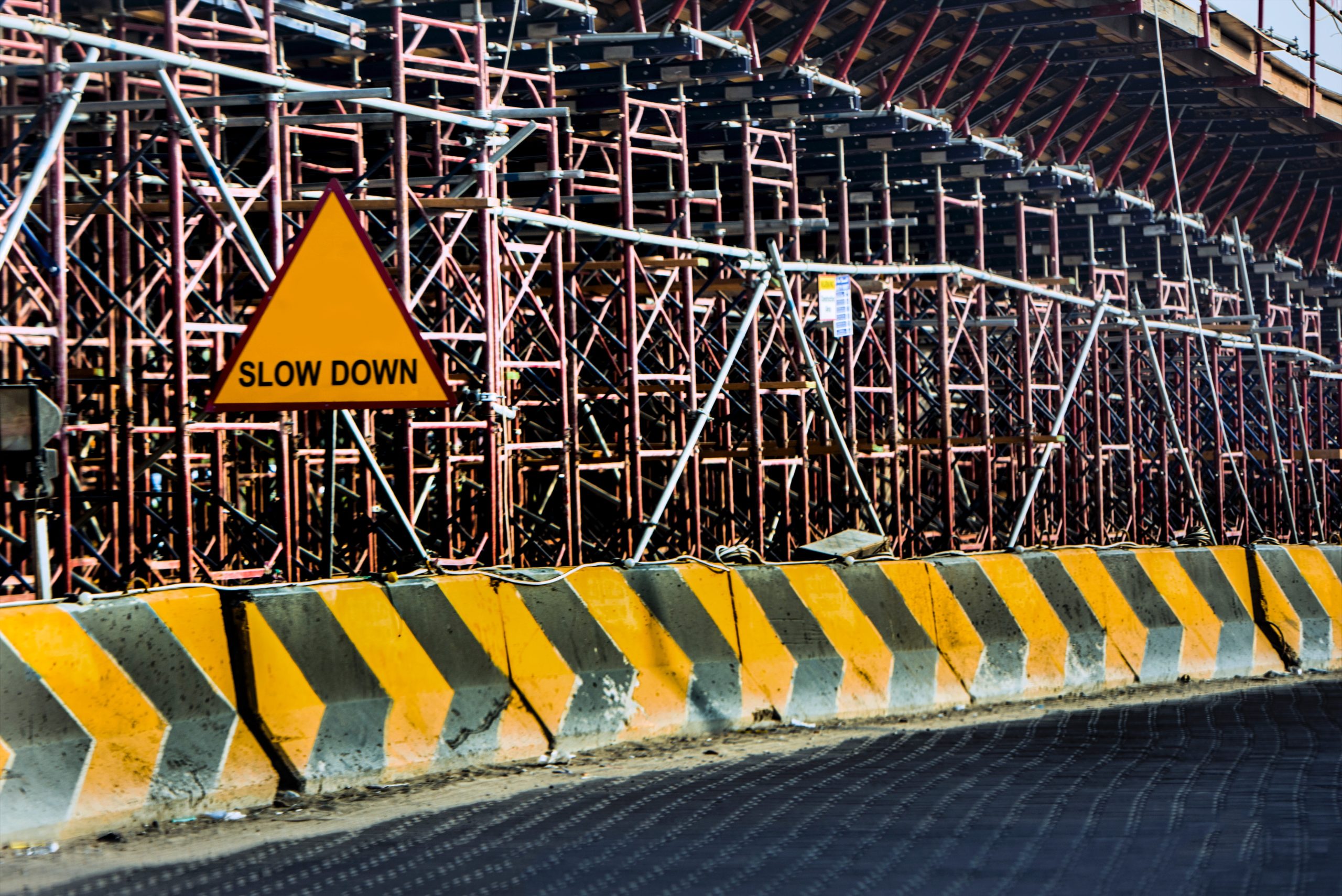 yellow-and-black-road-concrete-barrier-638487-scaled