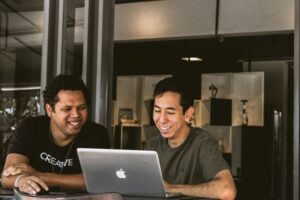 Two men looking at computer