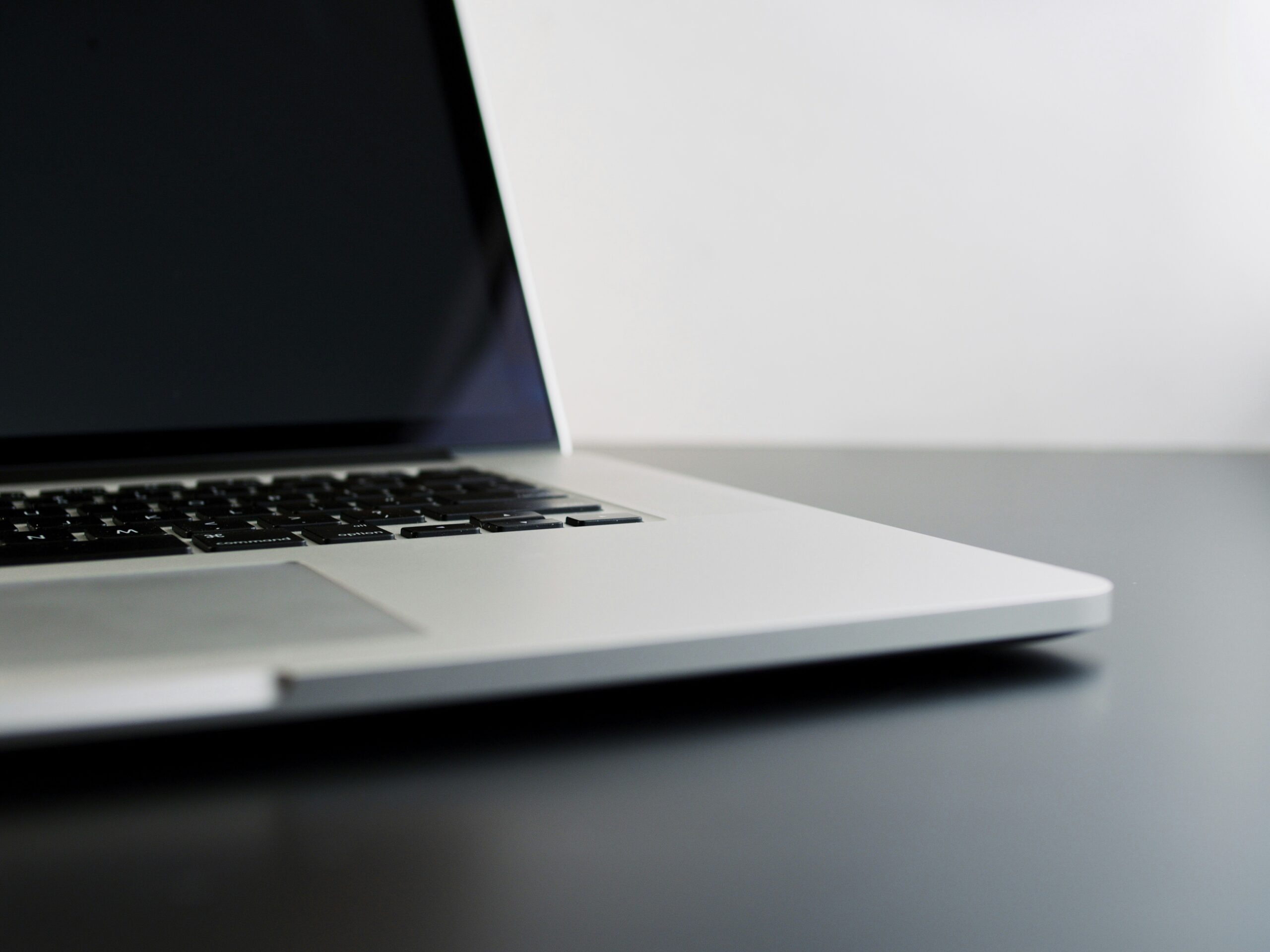 8-Considerations-Before-Buying-Used-Technology-scaledjpg silver laptop computer on black table