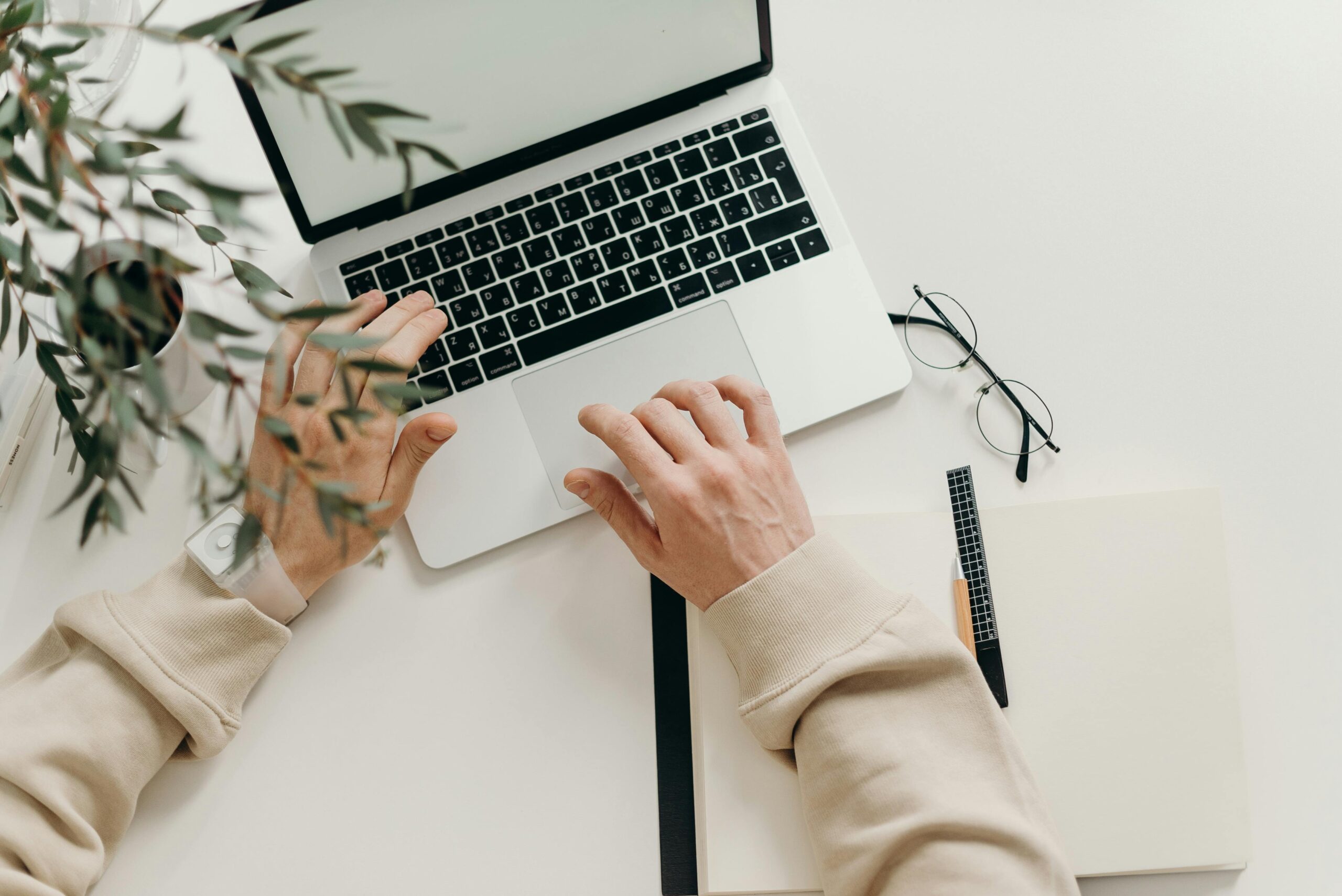 pexels-cottonbro-4065876-scaledjpg Free An overhead view of a person working on a laptop in a minimalist home office setting. Stock Photo